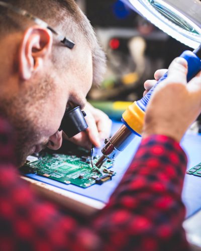 man-soldering-motherboard-at-workplace-9U4BG7X.jpg